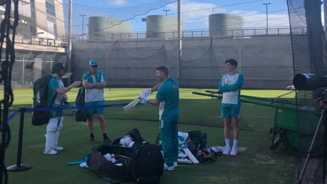 David Warner and Sean Abbott, right, talk to Steve Smith from a safe distance at the MCG. Picture: Peter Lalor