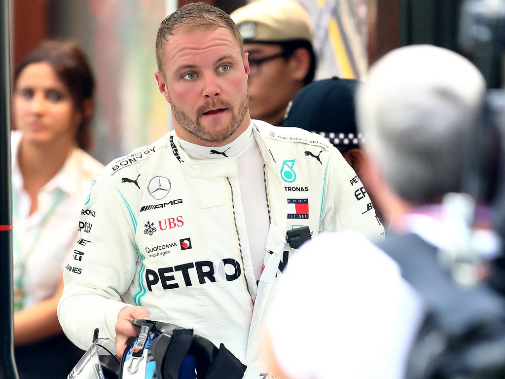 Valtteri Bottas walks back into the paddock after crashing during practice.