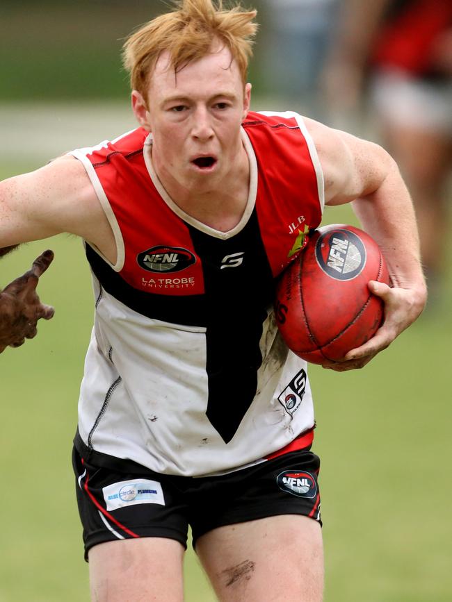 NFL: Watsonia’s Ben Callaghan tries to escape a tackle. Picture: Stuart Milligan