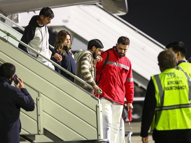 Airport ground staff and medics assist Azerbaijani citizens, who survived the crash. Picture: Getty Images