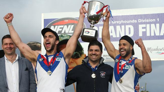 West Preston-Lakeside co-captains Nathan Valladares and Ahmed Saad lift the premiership cup with coach Rob Maiorana in the middle. Picture: Hamish Blair