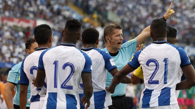 Referee Daniele Orsato warns off Honduras players during the first leg in San Pedro Sula, Honduras. Picture: AP