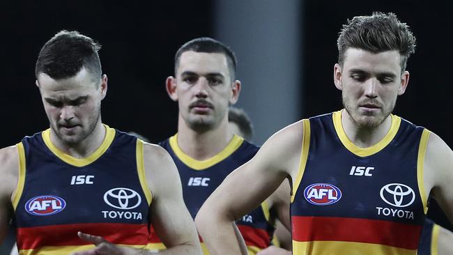 Brad Crouch, Taylor Walker and Paul Seedsman walk off after the loss. Picture SARAH REED