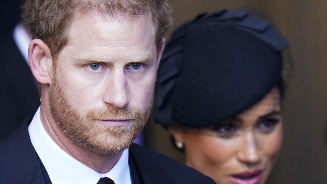 Harry and Meghan leave the service. (Photo by Danny Lawson / POOL / AFP)