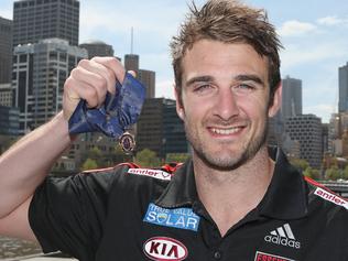 MELBOURNE, AUSTRALIA - SEPTEMBER 25:  2012 Brownlow Medallist Jobe Watson of the Essendon Bombers AFL team poses holding the Brownlow Medal at a press conference at Crown Promenade on September 25, 2012 in Melbourne, Australia.  (Photo by Scott Barbour/Getty Images)