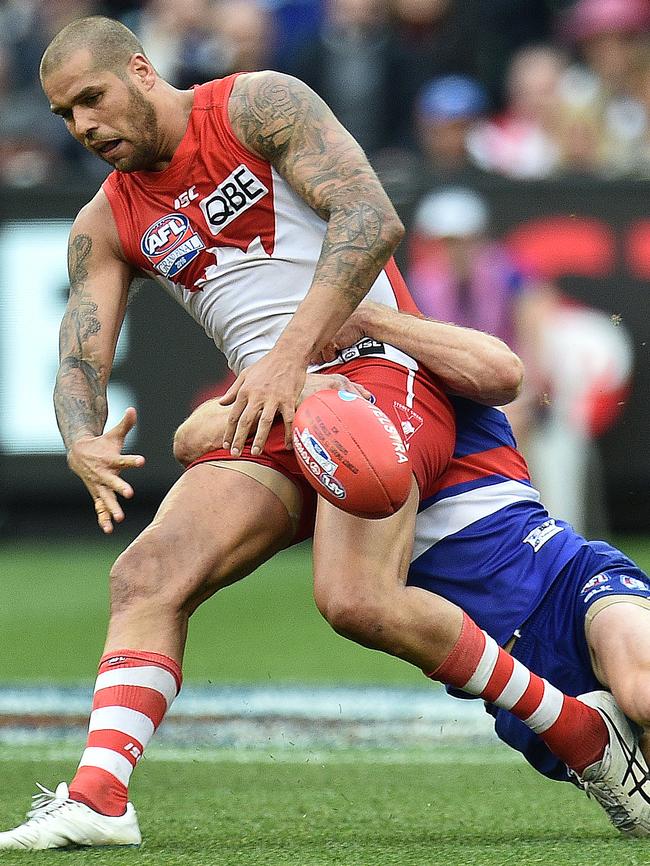 Lance Franklin is chased down by Dale Morris.