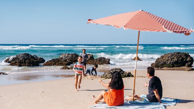 Holidaying at home has never been better. A family playing in the rock pools at Kirra Beach on the Gold Coast. Picture: TEQ