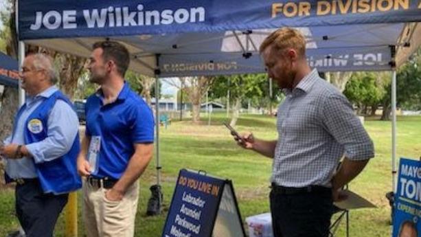 Mayor Tom Tate and suspended councillor Ryan Bayldon-Lumsden at the Runaway Bay pre-polling centre for the 2024 election. To their right, Division 7 candidate Joe Wilkinson.