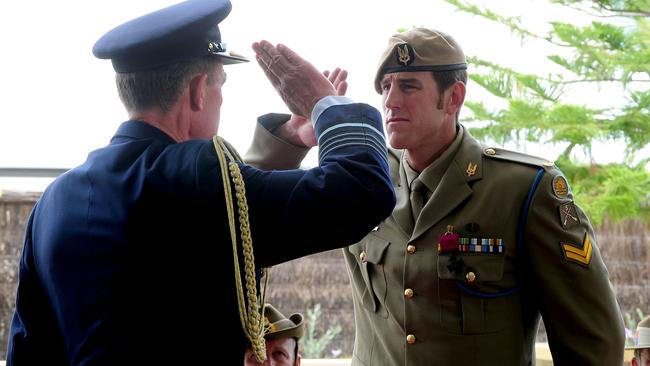 Chief of the Defence Force, Air Chief Marshal Angus Houston, salutes Ben Roberts-Smith during the VC award ceremony in January 2011. Picture: Department of Defence