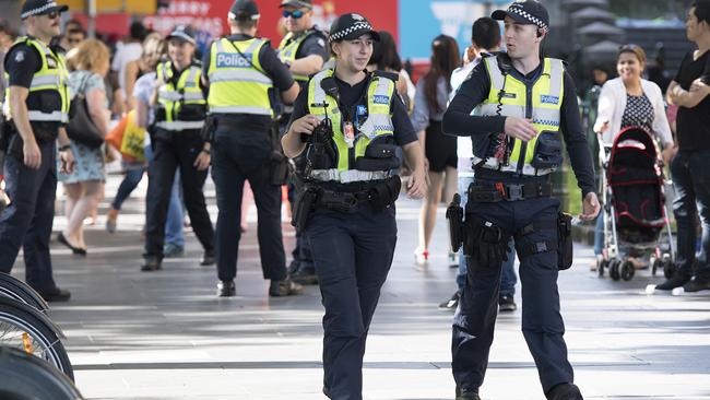 Police walk along Swanston Street ahead of the New Year's Eve celebrations in Melbourne. Picture: AAP.