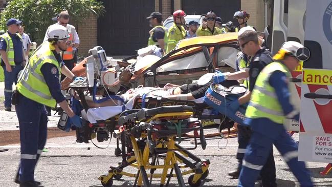 A patient is loaded into an ambulance at Milperra. Picture: TNV