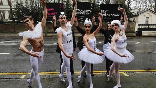 Ballet dancers join Amnesty International activists during a photocall outside the Russian Embassy in London on January 29, 2014. The dancers performed parts of Swan Lake before handing in a petition asking that Russia's President Putin 'end his assault on freedom of expression and gay rights in Russia'.