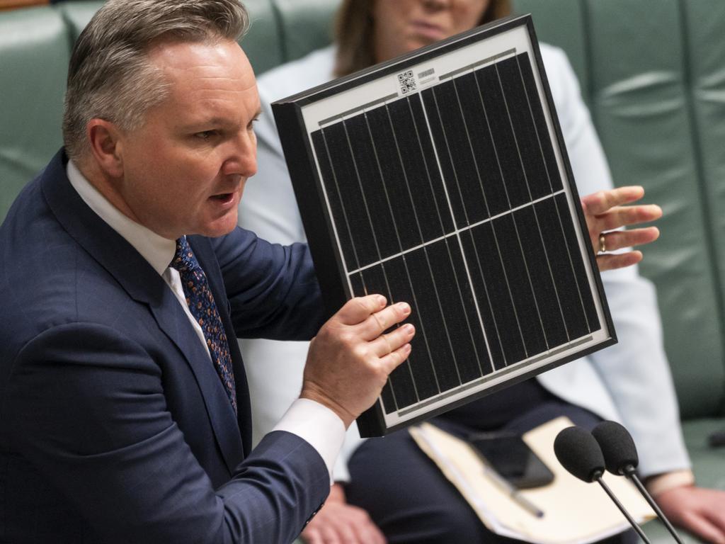 Chris Bowen MP holds up a solar panel during Question Time. Picture: Martin Ollman / NCA NewsWire