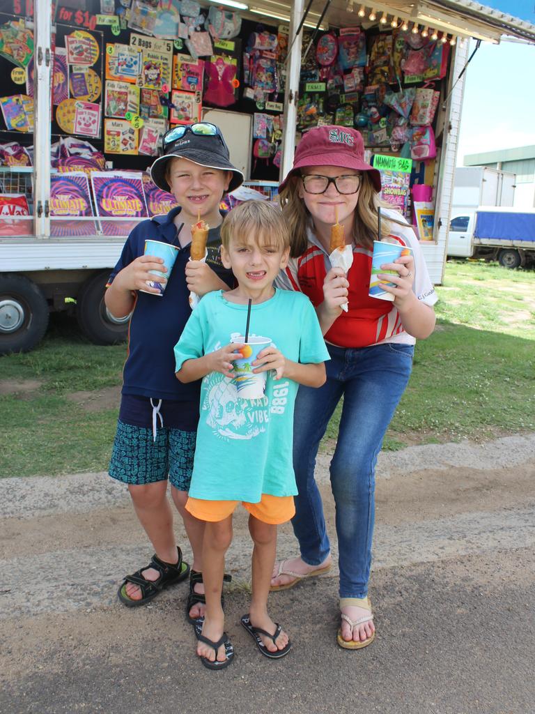 HAPPY DAYS: Karmicheal Armstrong, Jayden Mcaleese and Kelliegh Armstrong tucking into some food at the Murgon Show at the Murgon Show. Photo: Laura Blackmore