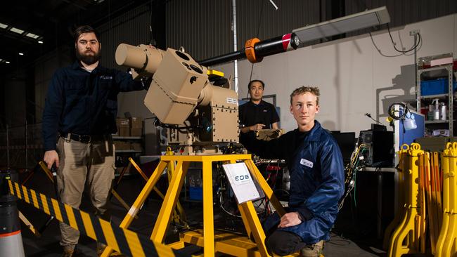 Electro Optic Systems production technicians with a automated weapons system. Picture by Sean Davey.