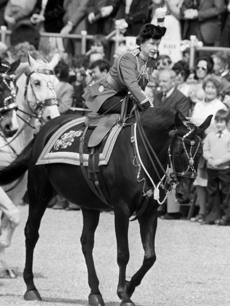 Her Majesty leans forward to reassure her horse Burmese after a man fired several blanks before entering Horse Guards Parade in 1981. Picture: Getty