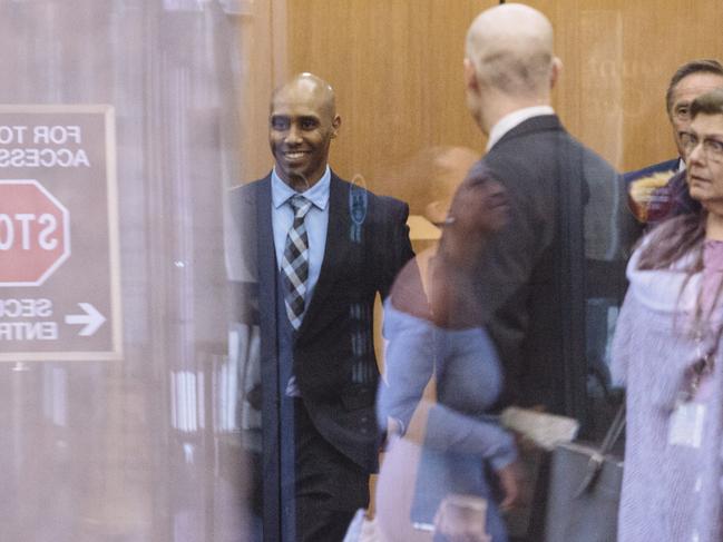 Mohamed Noor smiles while arriving for a pre-trial hearing in relation to the death of Justine Damond. Picture: Angus Mordant