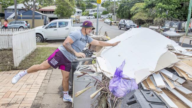 Brisbane Bronco Kotoni Staggs helps out with the clean up. Picture: Richard Walker