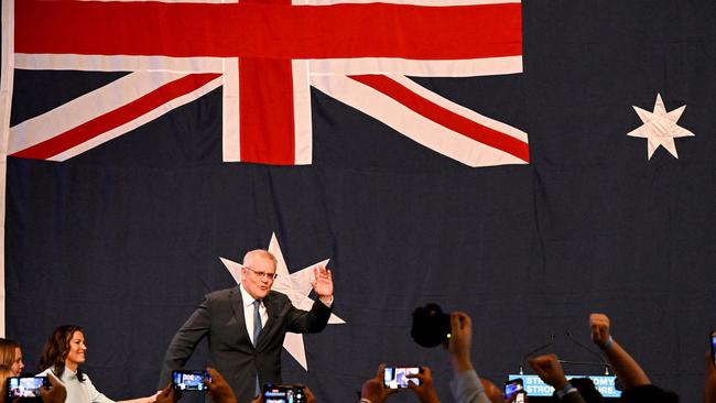 Scott Morrison waves as he arrives with his family to speak at a Liberal election night event in 2022.