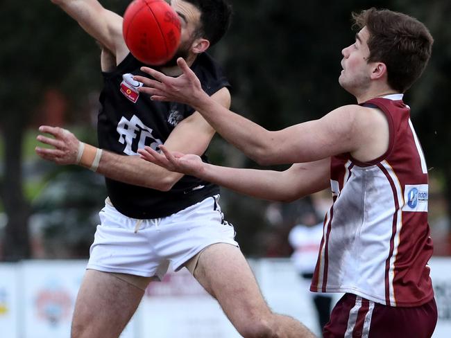 Anthony Perri of Burwood attempts to spoil Andrew Padbury of the Pioneers during the EFL (Division 4) football match between  Whitehorse Pioneers and East Burwood at Springfield Park on Saturday 18th August, 2018.