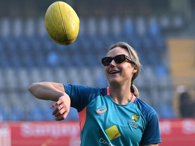 Australia's Ellyse Perry tosses up a rugby ball before the start of the final day play of the women's Test cricket match between India and Australia at the Wankhede Stadium in Mumbai on December 24, 2023. (Photo by Indranil MUKHERJEE / AFP) / -- IMAGE RESTRICTED TO EDITORIAL USE - STRICTLY NO COMMERCIAL USE --