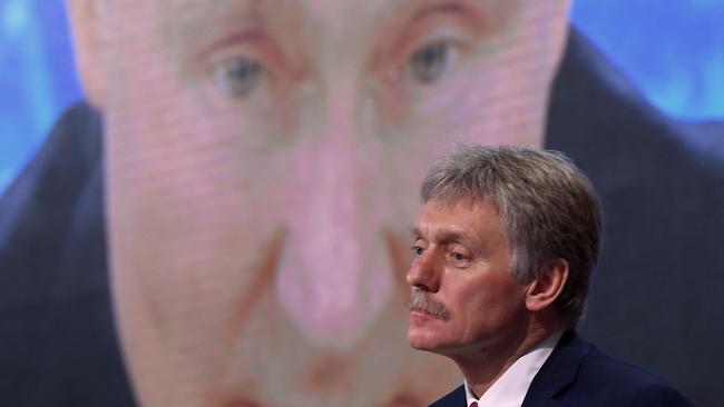 (FILES) In this file photo taken on December 17, 2020, Kremlin spokesman Dmitry Peskov sits in front of a screen displaying Russian President Vladimir Putin addressing his annual press conference via a video link from the Novo-Ogaryovo state residence, at the World Trade Centre's congress centre in Moscow. - Russia would only use nuclear weapons in the context of the Ukraine conflict if it were facing an 