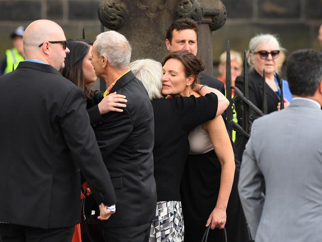 Staff members console one another. Picture: Quinn Rooney/Getty