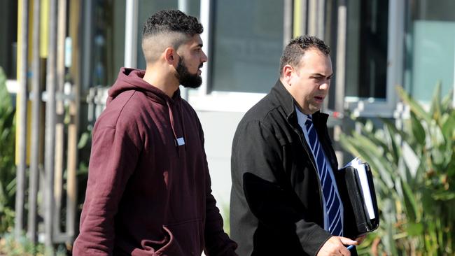 An unidentified man speaks to a detective outside Love Machine. Picture: Andrew Henshaw