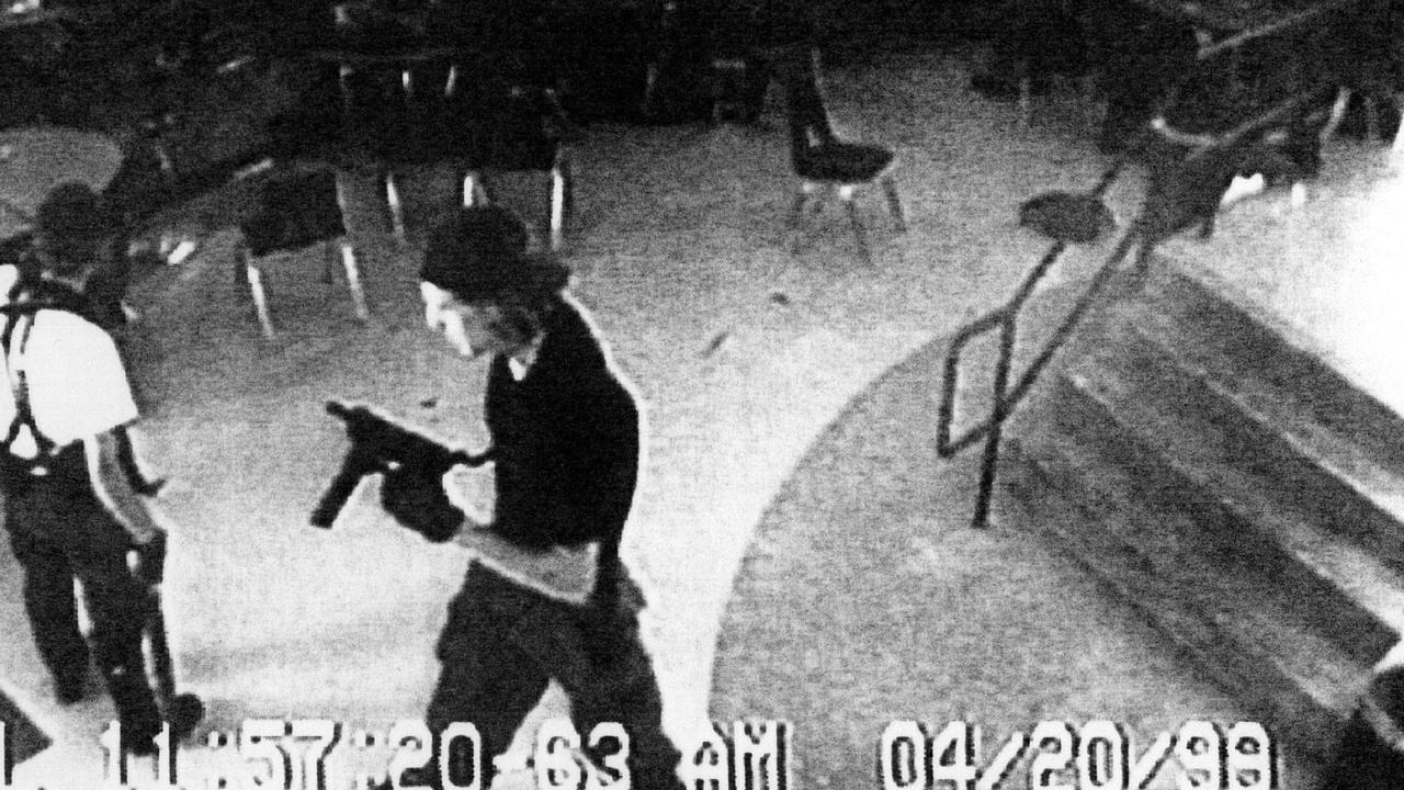 Eric Harris, left and Dylan Klebold, right, are shown on CCTV filmed inside a cafeteria during the Columbine shooting rampage. Picture: AP 