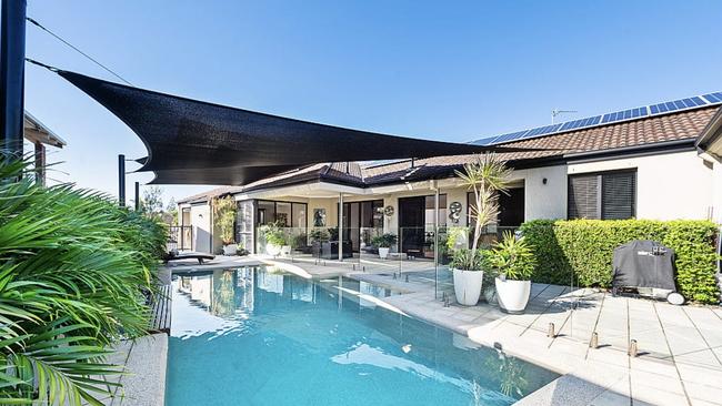 The Runaway Bay has five bedrooms, a triple garage, private jetty and a swimming pool. Picture: realesate.com