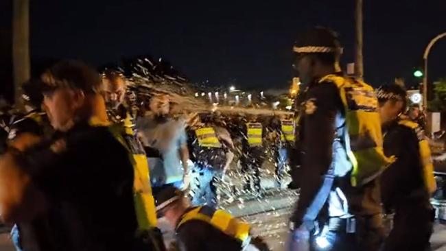 Video grabs of Pro-Palestinian and pro-Israel protestors clashing in Caulfield. Credit: Rukshan Fernando