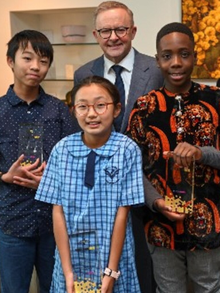 Prime Minister Anthony Albanese and winners of the 2022 Prime Minister's Spelling Bee, from left, Zachary Cheng, Joanne Lee and Ozi Egesi. Picture: Martin Ollman/NCA NewsWire