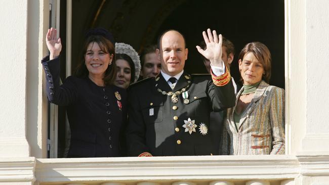Prince Albert, his sisters Princess Caroline of Hanover, left, and Princess Stephanie of Monaco, wave to the crowd at the Monaco palace in 2005. That year he formally assumed Monaco's throne. AP Photo/Lionel Cironneau