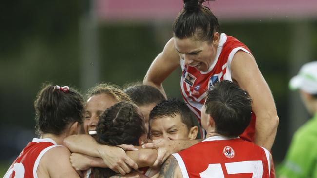 Waratah players are jubilant after winning their eighth Women’s Premier League flag at TIO Stadium last night. Picture: Glenn Campbell