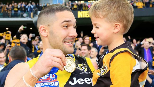 Shaun Grigg enjoys his premiership success with and son Sonny. Picture: Mark Stewart