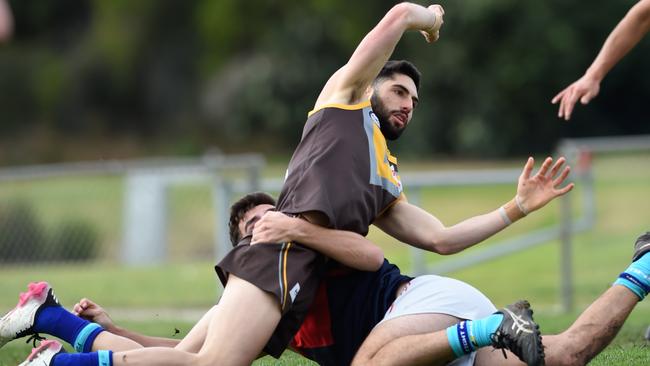 Ben Nesci gets the handball away. Picture: Steve Tanner