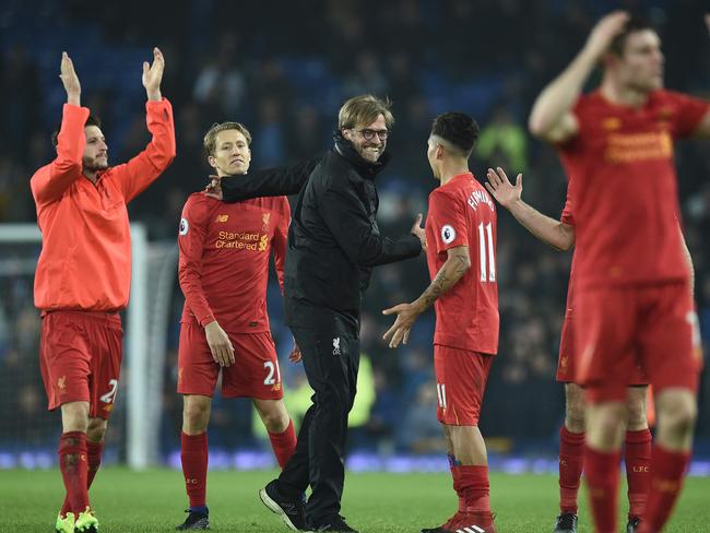 Liverpool's German manager Jurgen Klopp (C) congratulates his players.