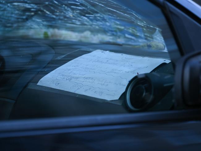 A handwritten note is seen inside the damaged car. Picture: Florian Wiegand / Getty