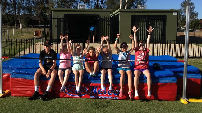 Members of Mt Druitt Little Athletics celebrating the club's new high jump flop bags.