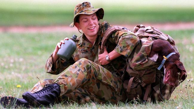 Officer cadet Keirin Joyce pictured in 2000 with dachshund-kelpie cross Dash, mascot of 17th Division in the Australian Defence Force Academy. Photo: Sandra Priestley.