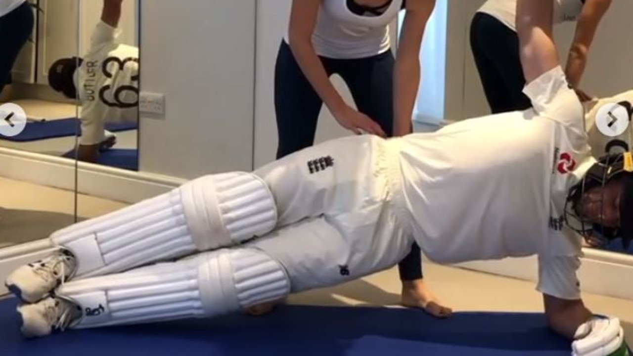 Jos Buttler does pilates in his full kit.