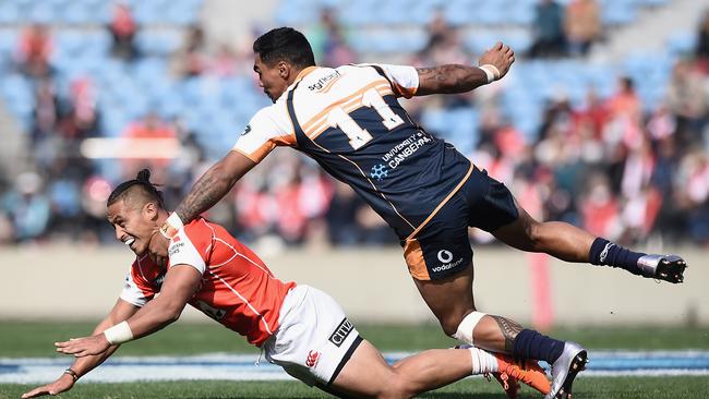 Jason Emery of the Sunwolves is tackled by Chance Peni-Ataera of the Brumbies during the Super Rugby round 2 match in Tokyo.