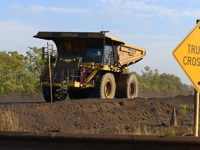 A haul truck drives past a crossing at South32's GEMCO manganese mining operation on Groote Eylandt.