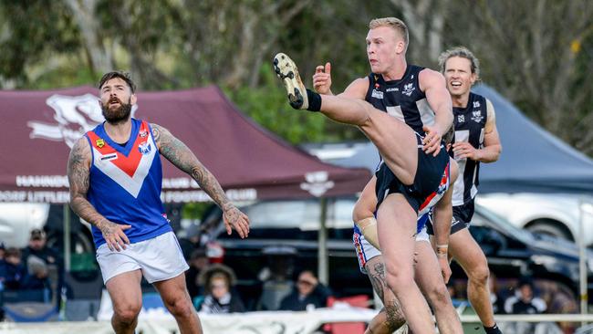 Sam Hayden from Hahndorf gets a kick off in last season’s Hills Football League grand final. Both country and city clubs will be affected by the player payment cut. Picture: AAP/Brenton Edwards