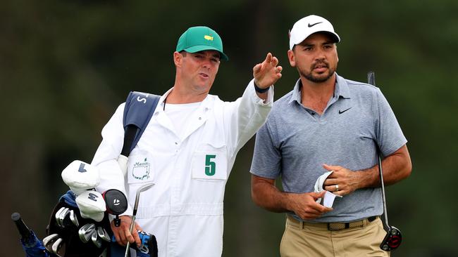 Jason Day talks with his caddie Luke Reardon on the 18th hole during the first round of the 2023 Masters. Picture: Getty Images