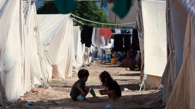 Children play among tents set up for Palestinians seeking refuge on the grounds of a United Nations Relief and Works Agency for Palestine Refugees centre in Khan Yunis in the southern Gaza Strip on October 19, 2023, amid the ongoing battles between Israel and the Palestinian group Hamas. Picture: Mahmud Hams/AFP