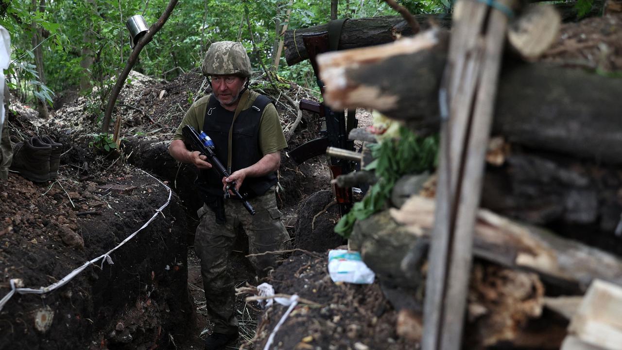 A Ukrainian serviceman walks along an entrenched position on the front line near Avdiivka, Donetsk region on June 18, 2022 amid the Russian invasion of Ukraine. Picture: Anatolii Stepanov / AFP