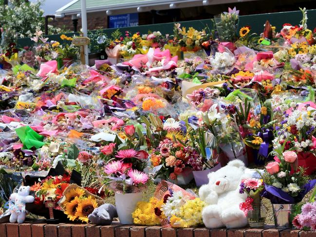 Floral tributes left on the front lawn of Dreamworld for the victims killed in 2016’s tragedy. Pic Tim Marsden