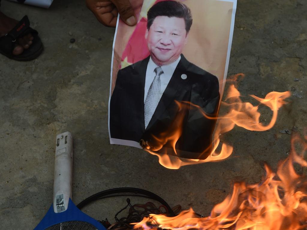 Members of the non-governmental organisation MADADGAAR PARIVAR, burn a poster of Chinese President Xi Jinping along with Chinese items as they protest against the killing of the three Indian soldiers by Chinese troops. Picture: SAM PANTHAKY / AFP.