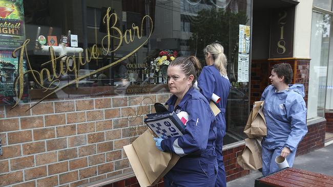 Forensic police leaving Antique Bar on Saturday. Picture : Ian Currie